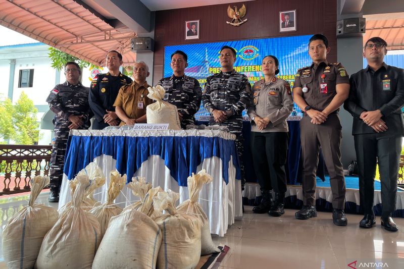 Petugas TNI AL menunjukkan puluhan karung pasir timah yang disita dari sebuah speedboat dalam pengungkapan dugaan penyelundupan di Karimun, Kepulauan Riau.