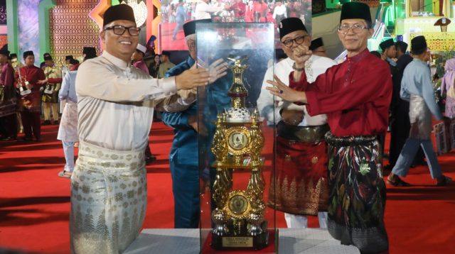 Wali Kota Batam Amsakar Achmad menerima piala juara umum MTQH XII Kepulauan Riau.